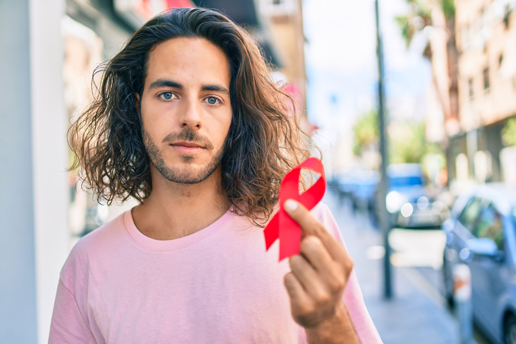 latino male with HIV ribbon